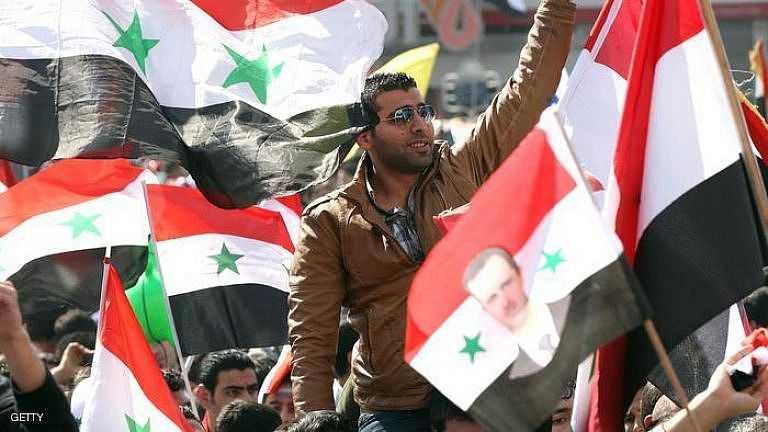 Syrian flags are waved as people take to