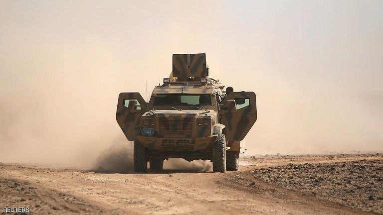 Syrian Democratic Forces(SDF) fighters ride a military vehicle north of Raqqa city