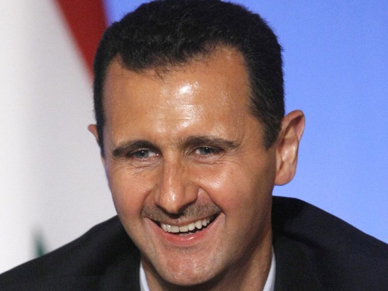 Syria's President Bashar al-Assad smiles during a news conference at the Elysee Palace in Paris